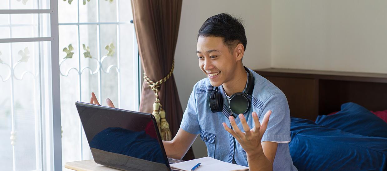 Student with laptop taking online class